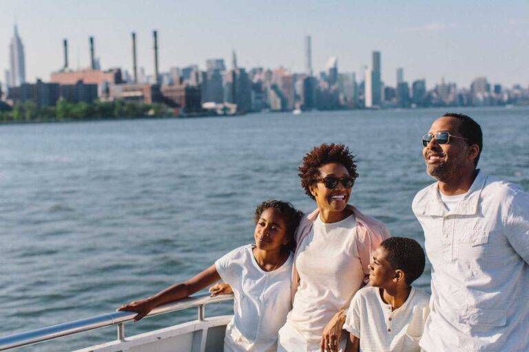 Family smiling on boat tour USE THIS ONE